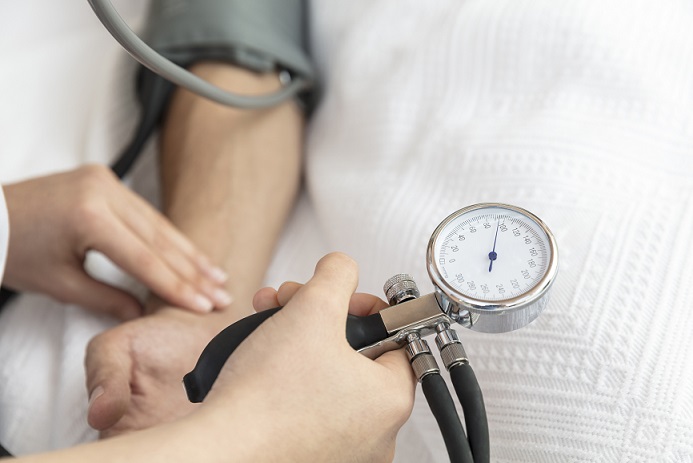An obstetricians measuring blood pressure during a pregnancy check-up